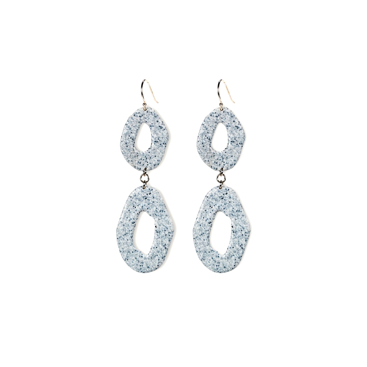 Pair of glittery silver earrings on a white background