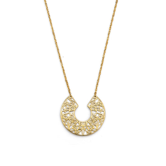 Gold necklace with a intricate pendant on a white background