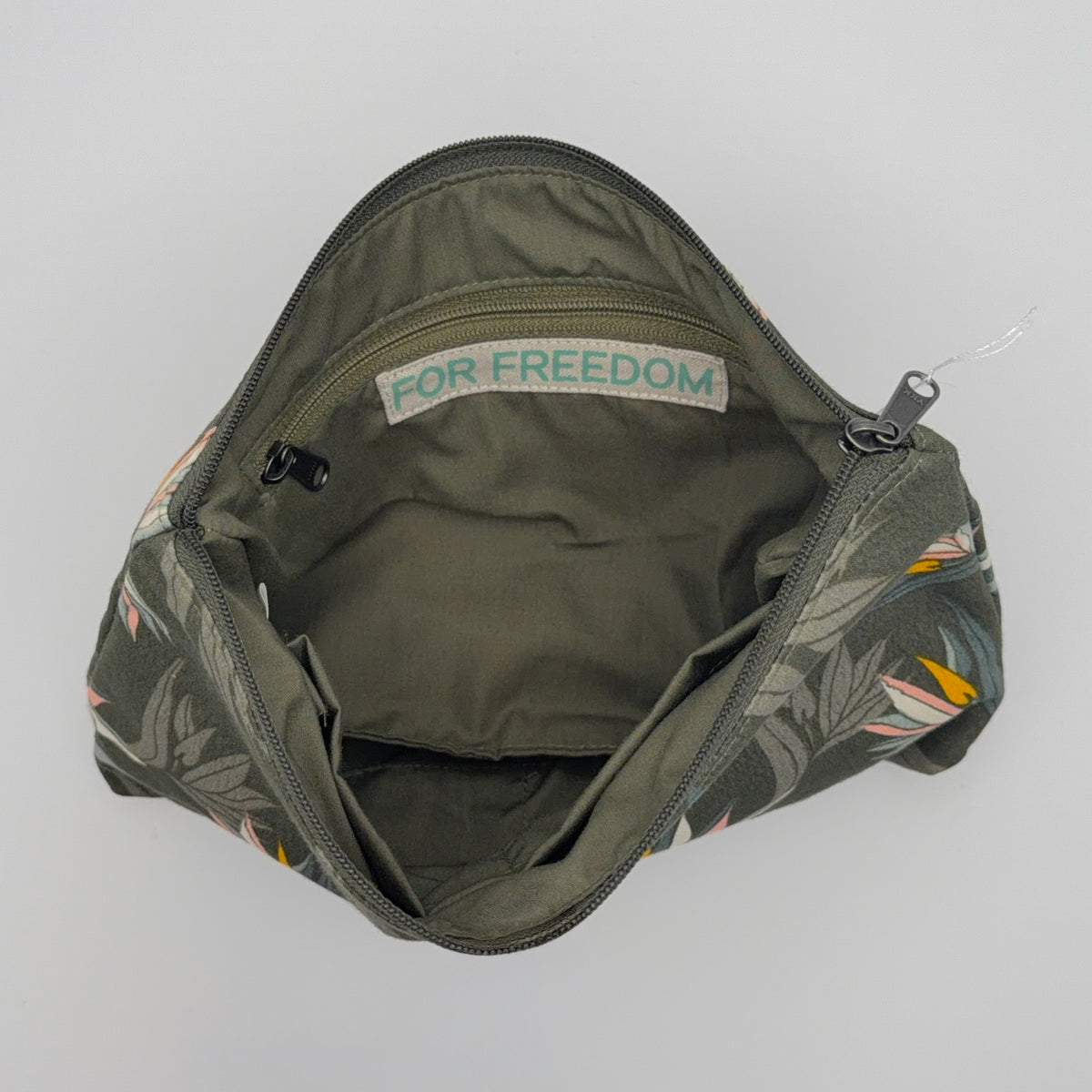 Green bag with floral pattern on a gray background