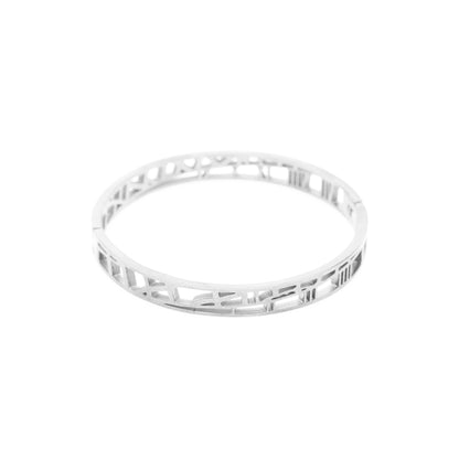 Silver bracelet with intricate design on a white background