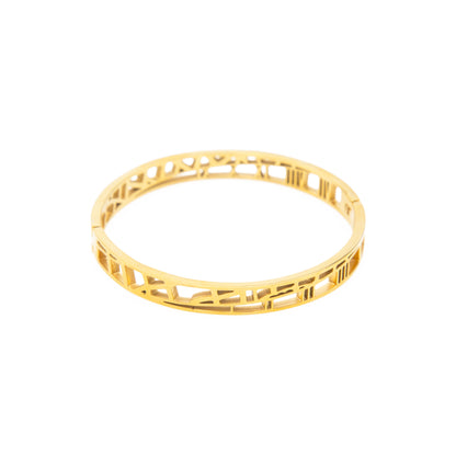 Gold bracelet with intricate design on a white background