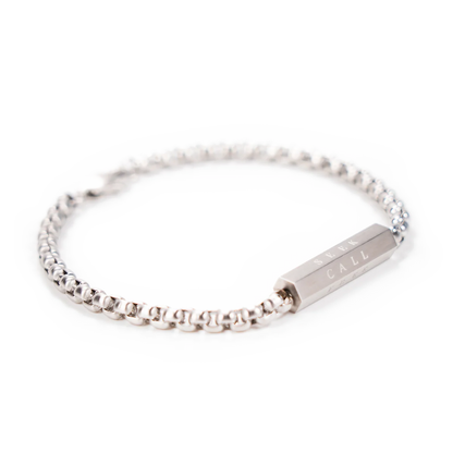 Silver bracelet with a nameplate on a white background