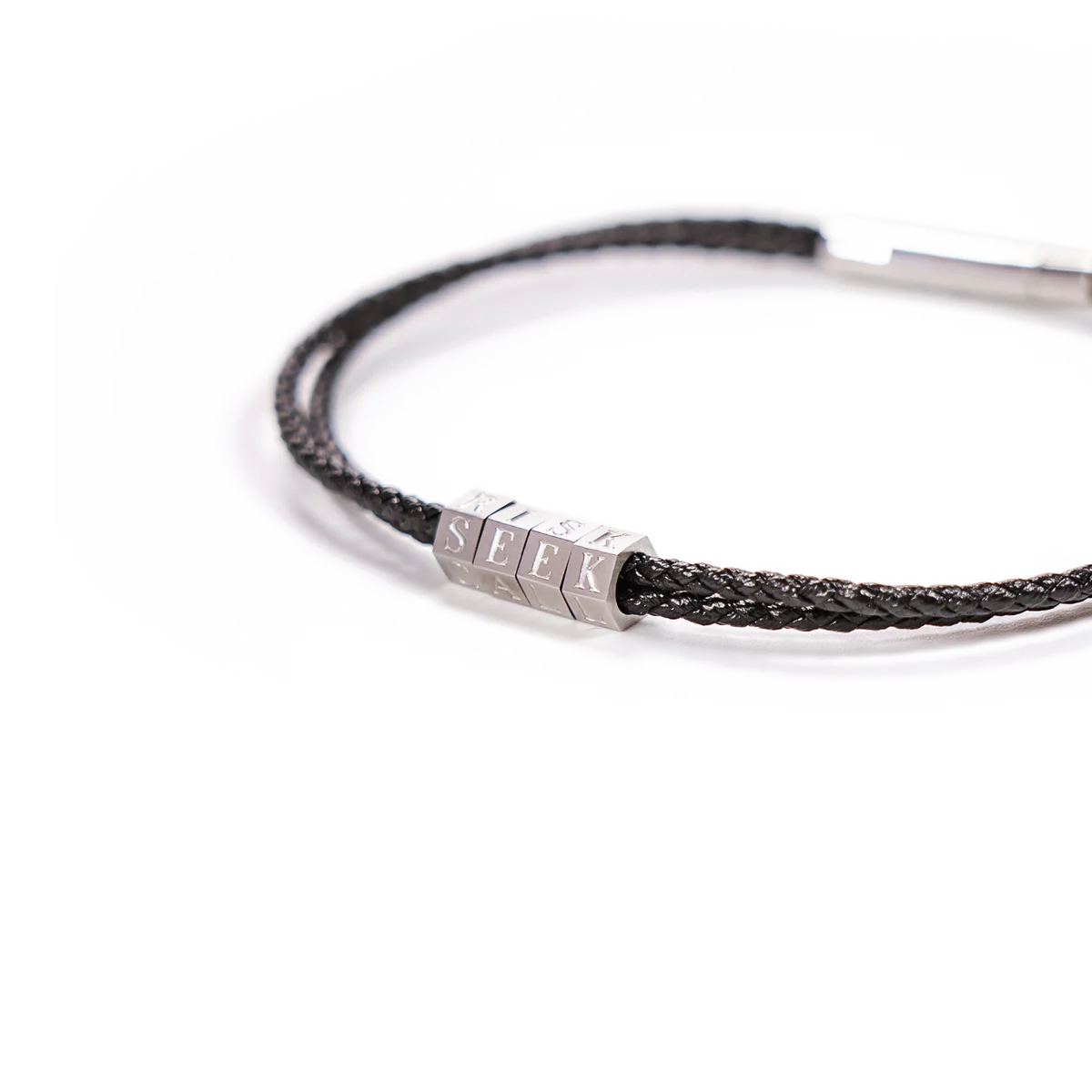 Bracelet with braided design and hexagonal metal tag on a white background