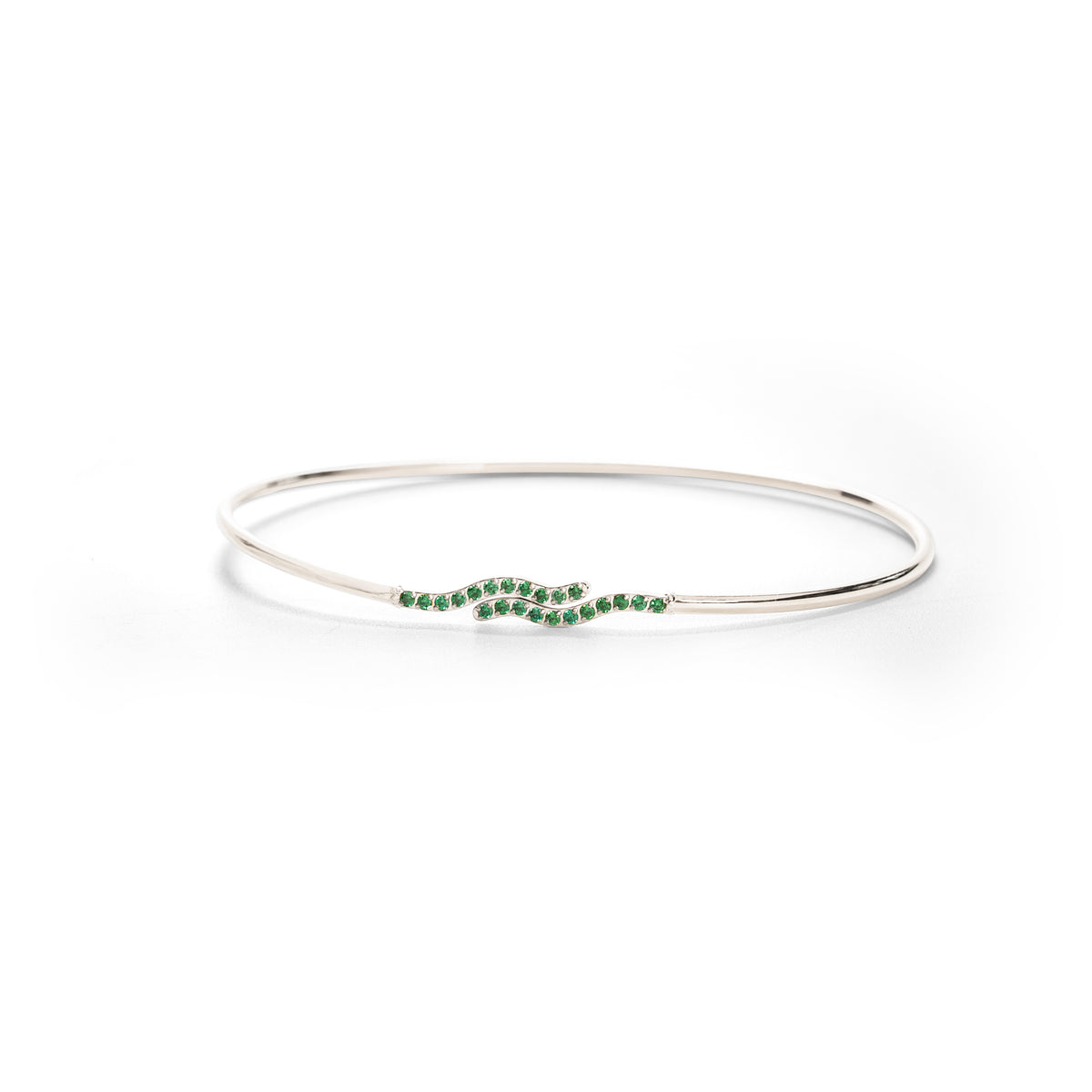 Silver bangle with green stones on a white background