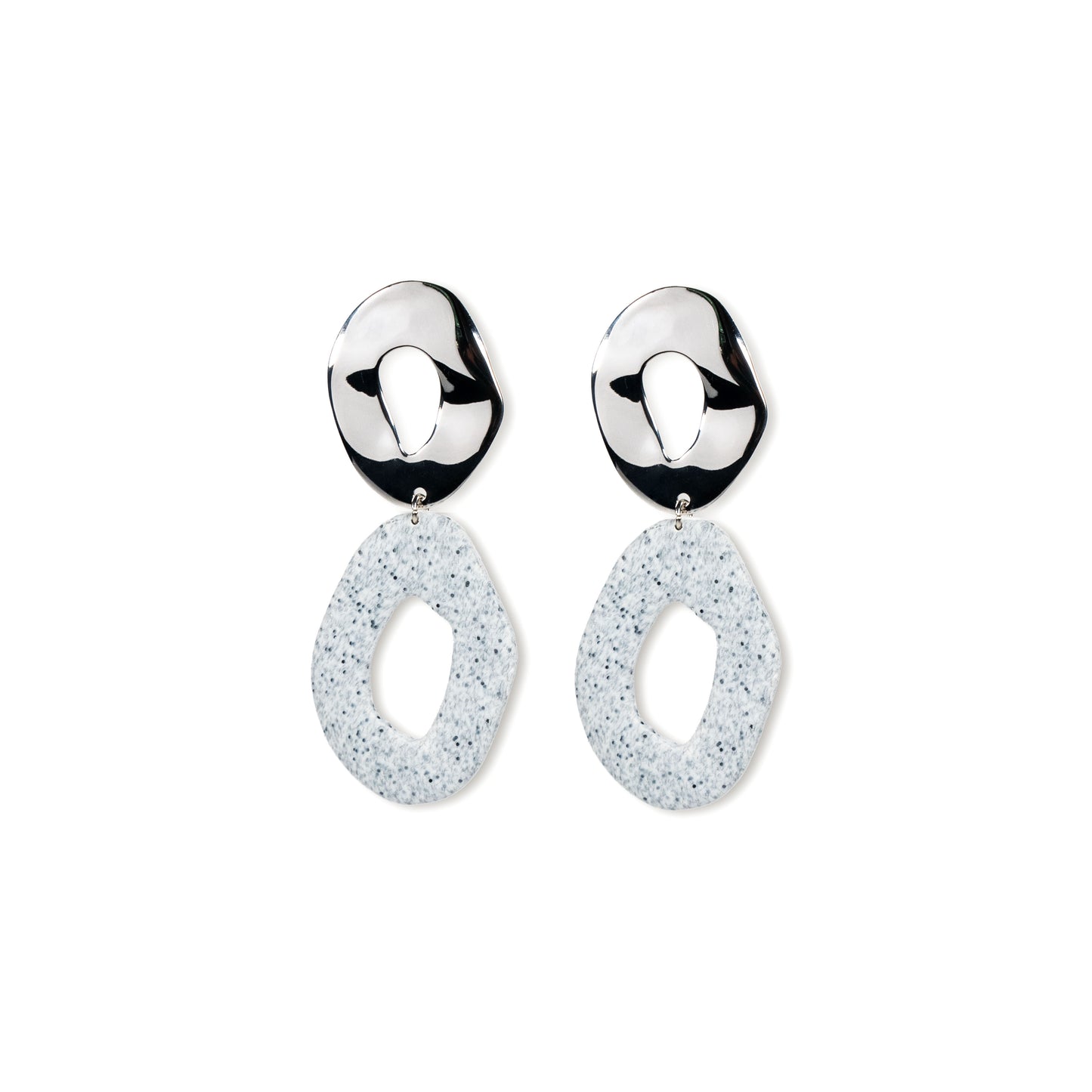 Pair of silver earrings with white speckled drops on a white background