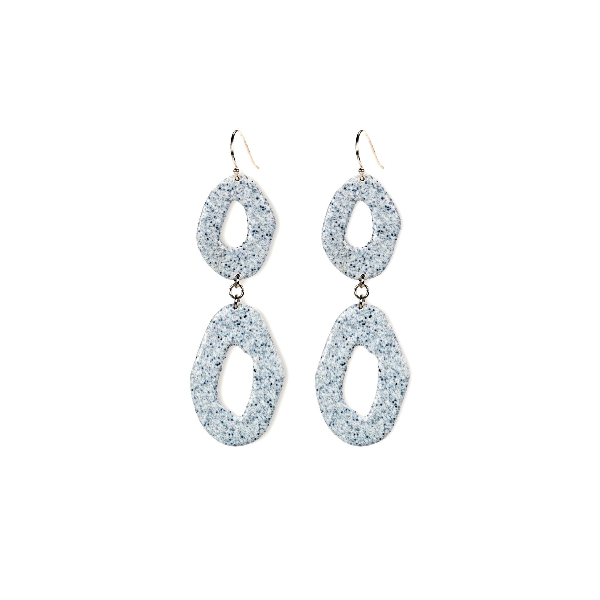 Pair of glittery silver earrings on a white background