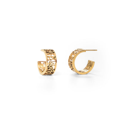 Gold hoop earrings with intricate designs on a white background