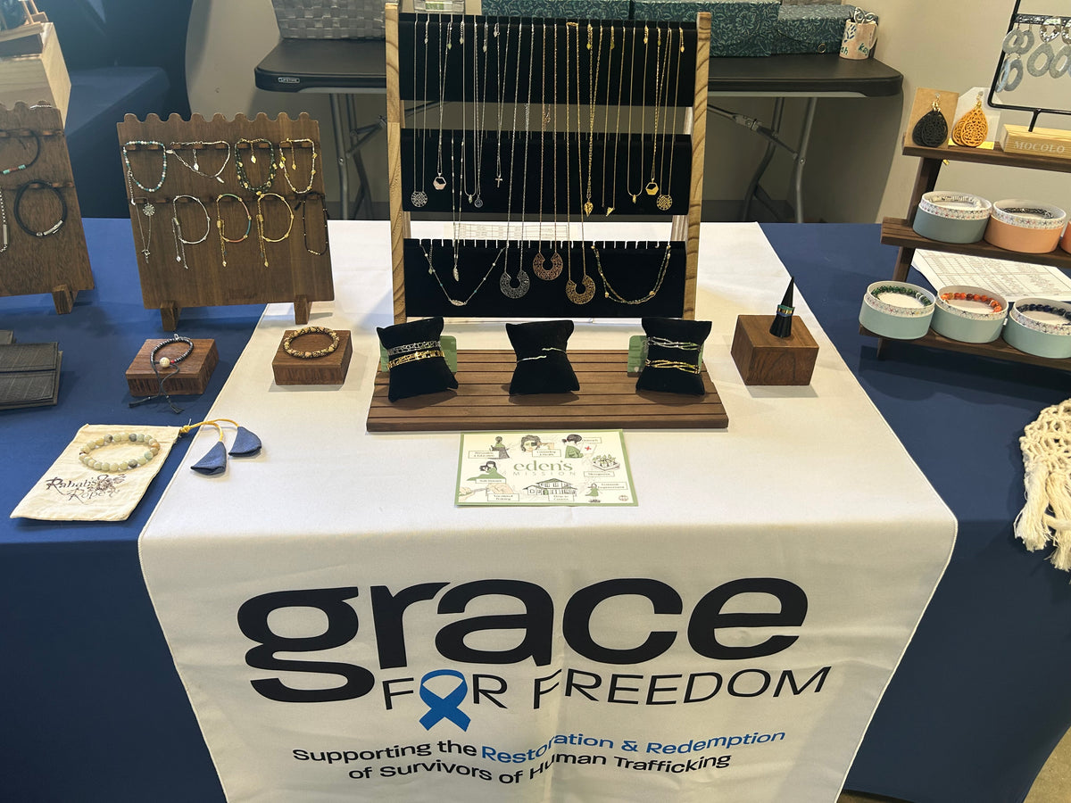 table with jewelry for sales and banner that reads Grace for Freedom