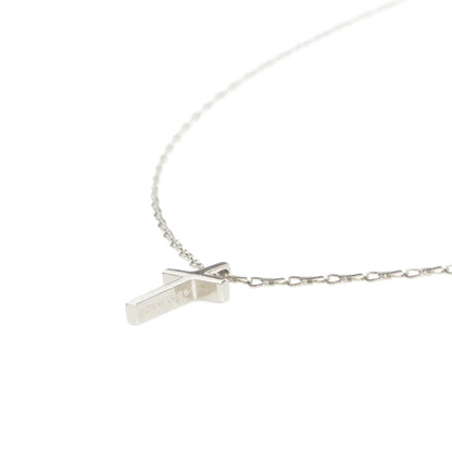 Silver necklace with a small pendant on a white background