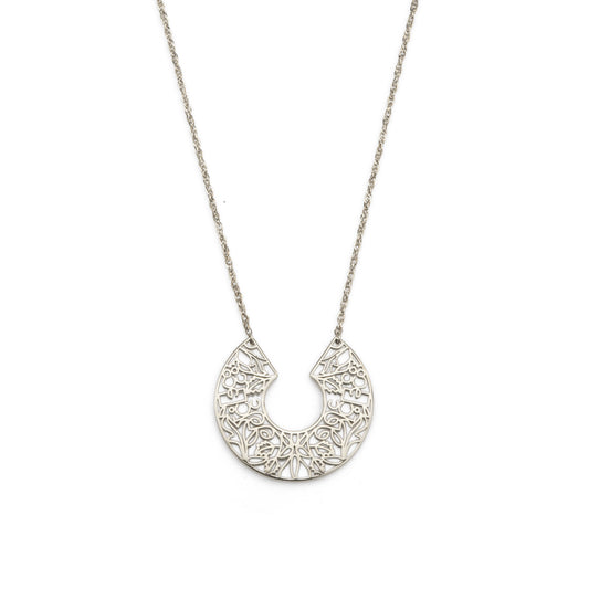 Silver necklace with a detailed half-circle pendant on a white background