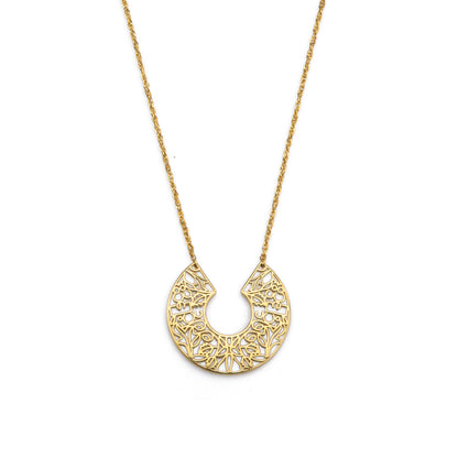 Gold necklace with a intricate pendant on a white background