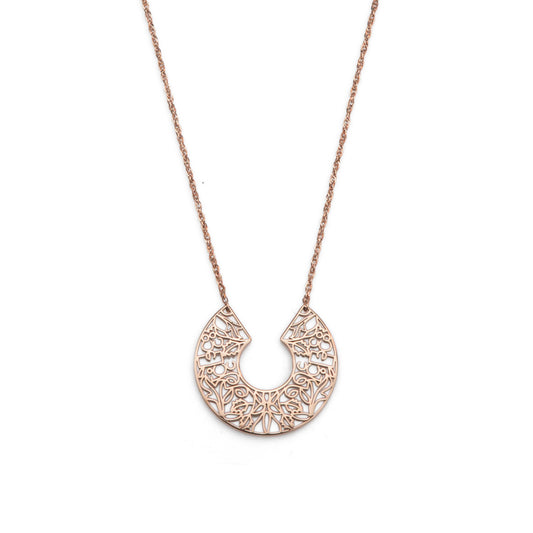Rose gold necklace with a intricate pendant on a white background
