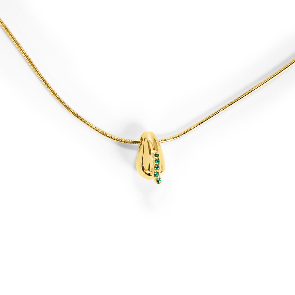 Gold necklace with a pendant featuring green gemstones on a white background