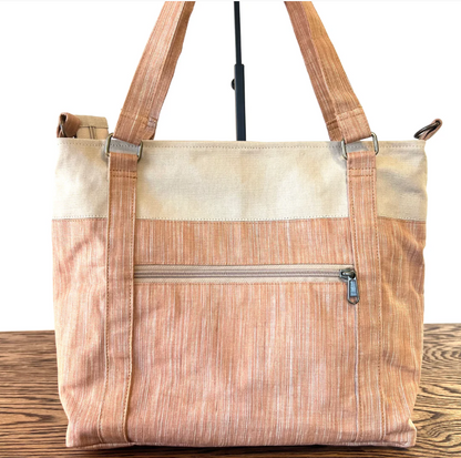 Tote bag with wooden handle and natural fabric on a wooden surface