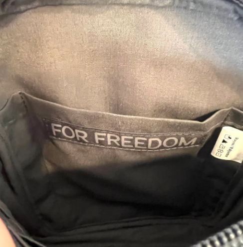 Gray bag with 'FOR FREEDOM' label on a dark background