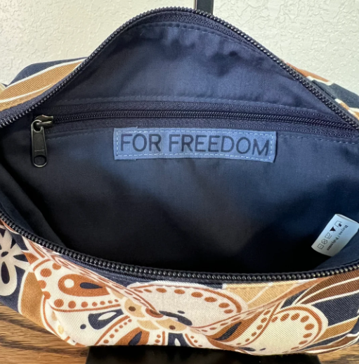 Patterned bag with 'FOR FREEDOM' label on a neutral background