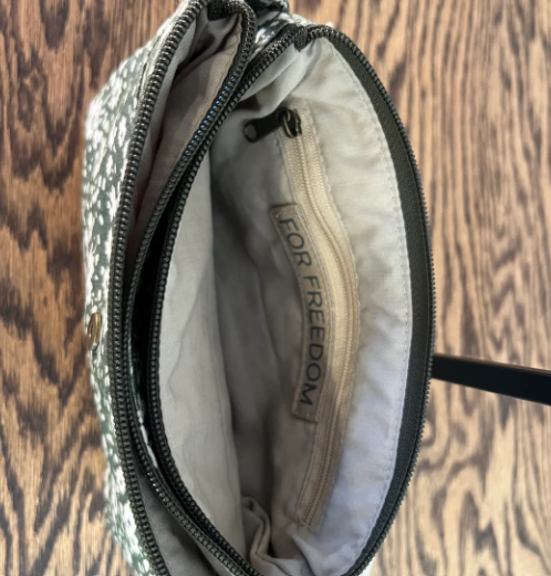 Open bag with 'For Freedom' branding on a wooden surface