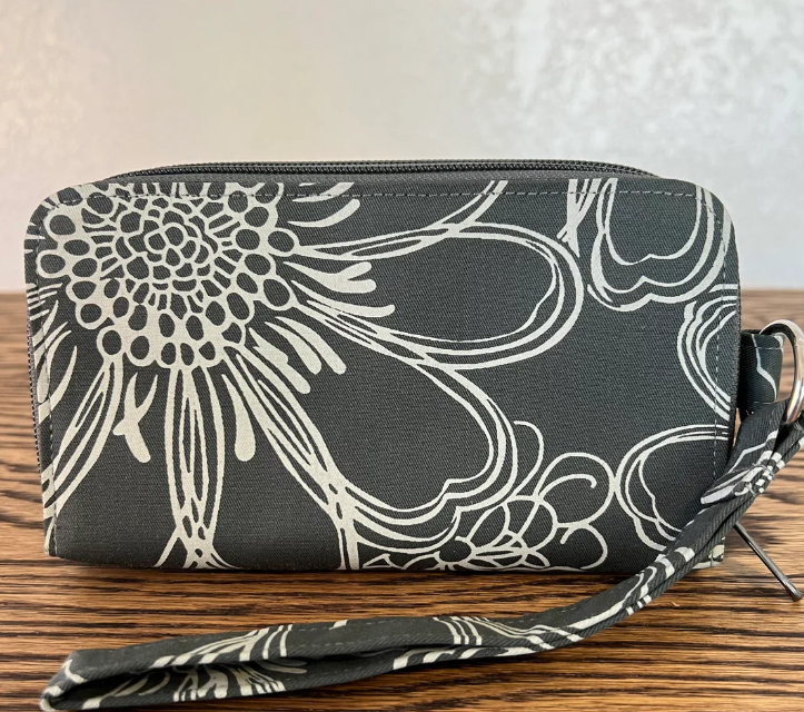 Floral patterned wallet on a wooden surface