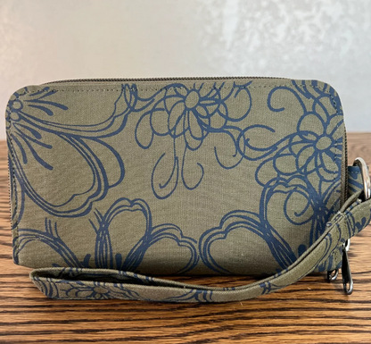 Floral patterned clutch bag on a wooden surface with a neutral background