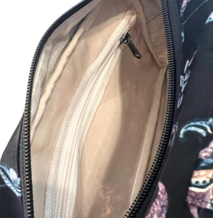 Close-up of a black bag with a zipper, showing the interior lining.