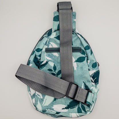 Sling bag with leaf pattern on a light gray background