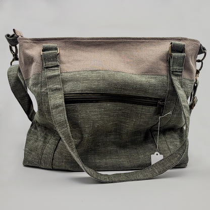 Gray and green bag with a visible brand tag on a gray background