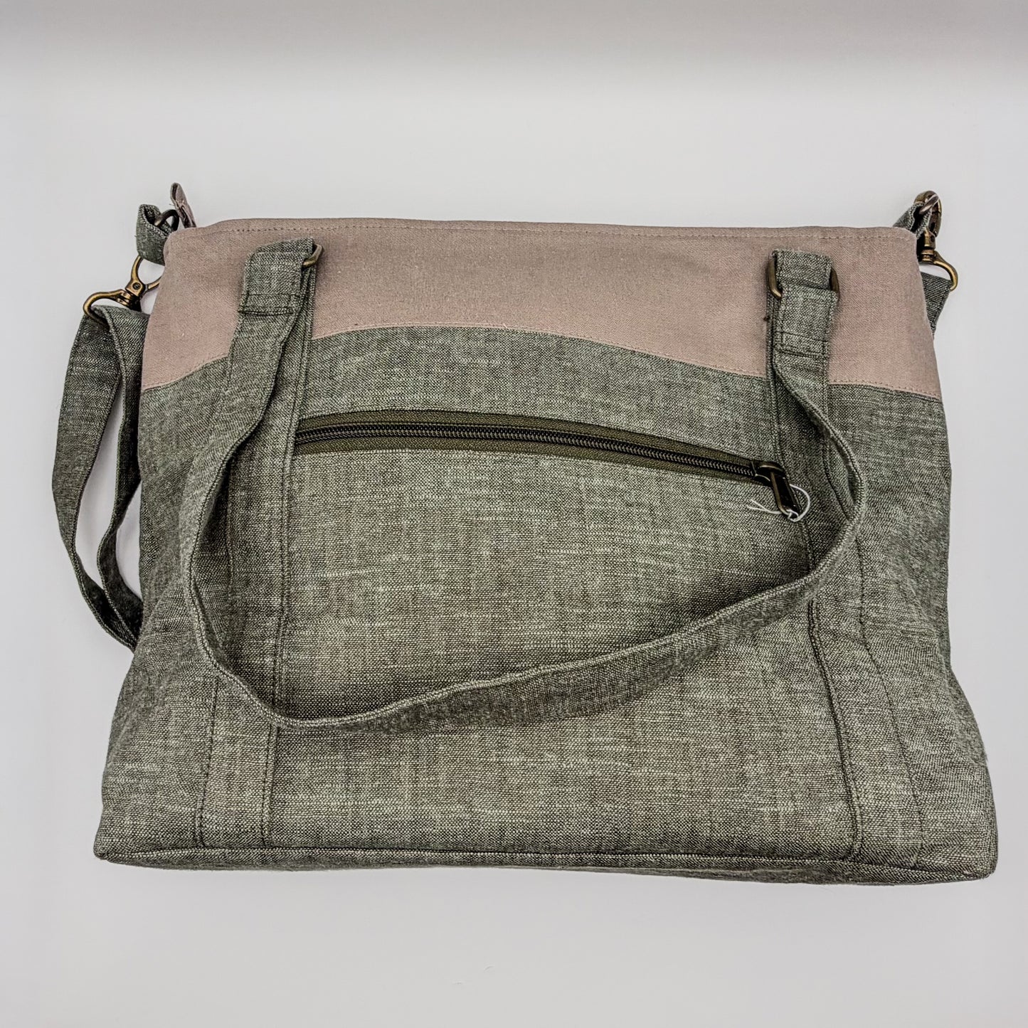 Two-tone crossbody bag with gray and beige sections on a white background