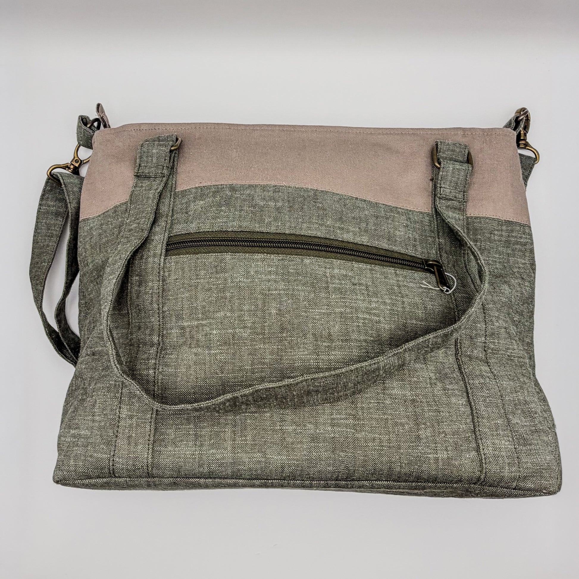 Two-tone crossbody bag with gray and beige sections on a white background