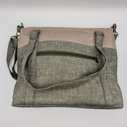 Two-tone crossbody bag with gray and beige sections on a white background