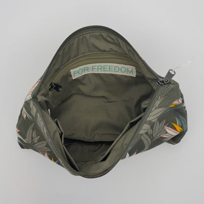 Green bag with floral pattern on a gray background