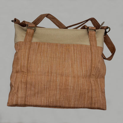 Brown textured bag with beige top section on a gray background