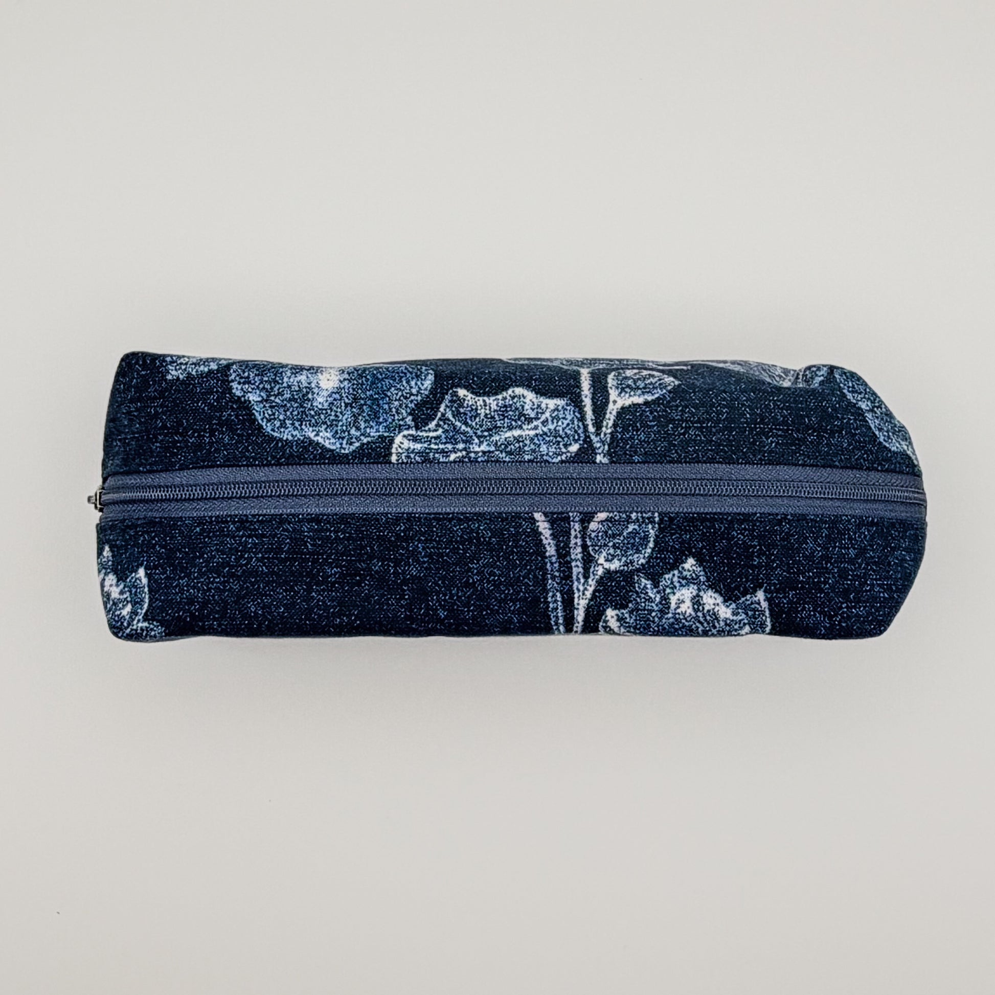 Pencil case with floral pattern and zipper on a light gray background