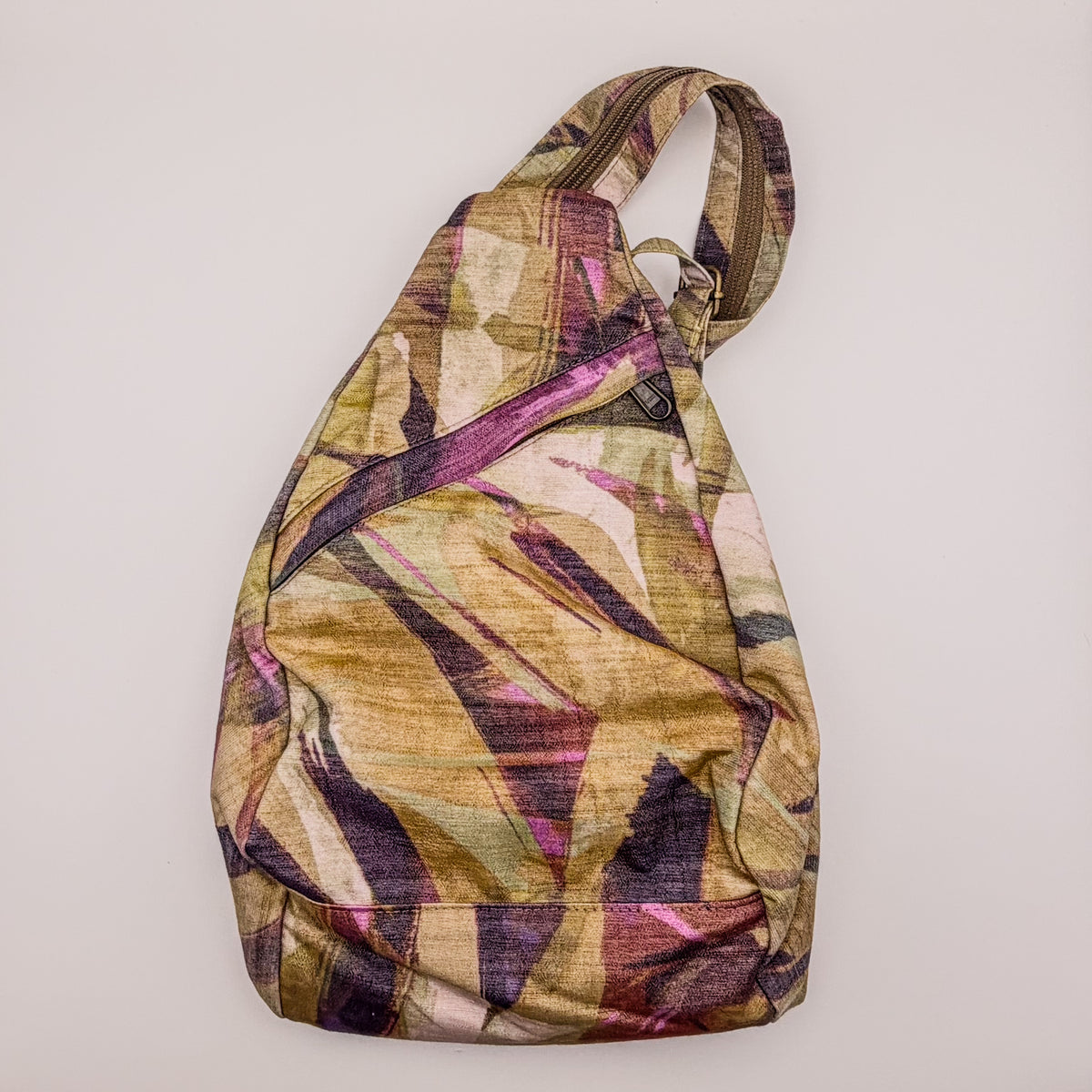 Multicolored sling bag on a light gray background