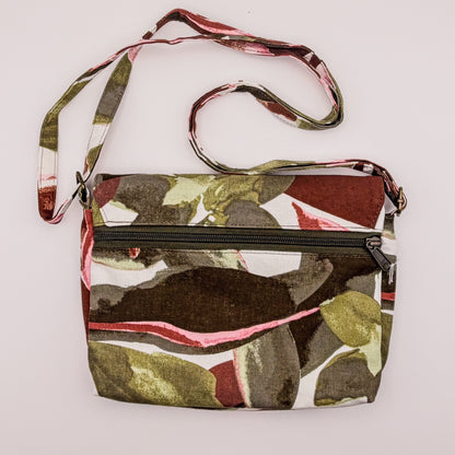 Camouflage-patterned crossbody bag with a strap on a white background