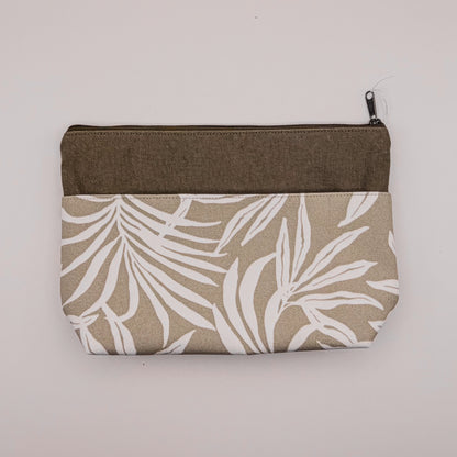 Fabric pouch with leaf pattern and brown zipper on a light gray background