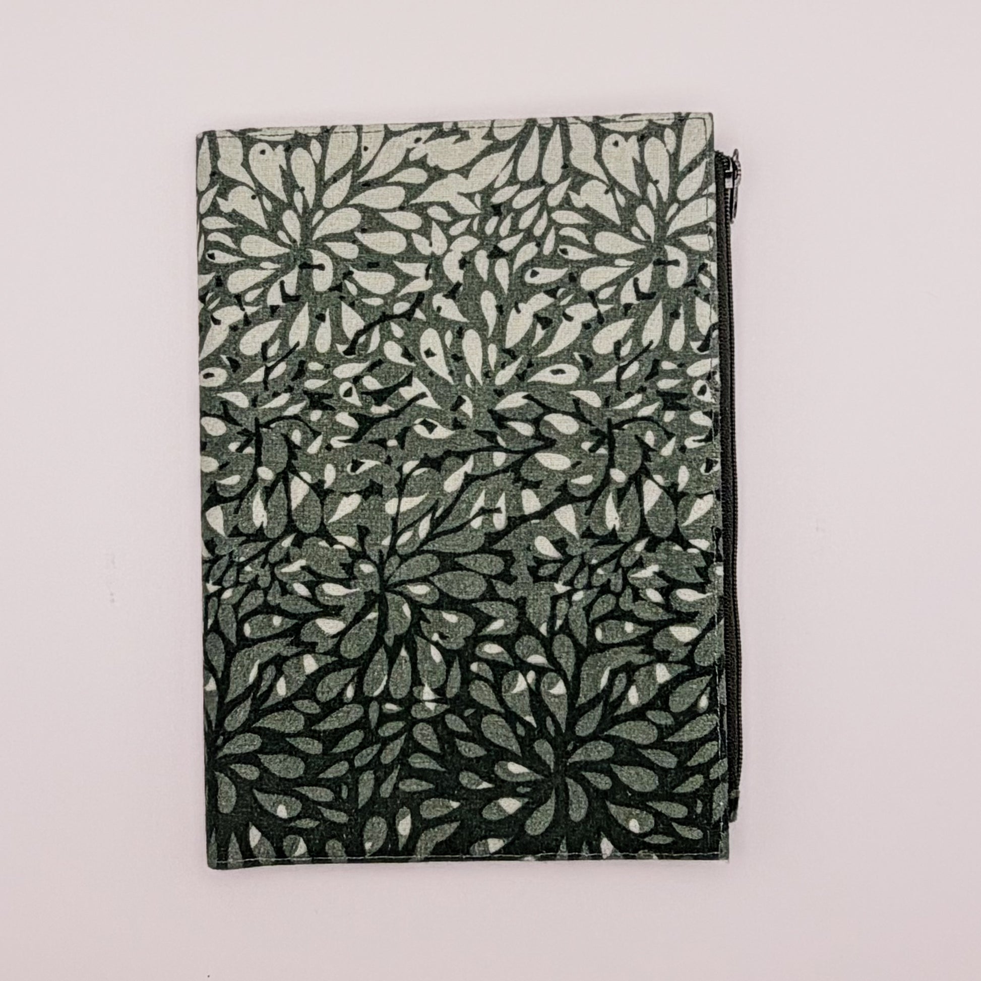 Folded fabric with leaf pattern on a light gray background