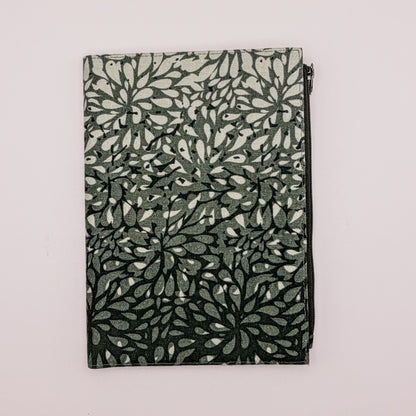 Folded fabric with leaf pattern on a light gray background