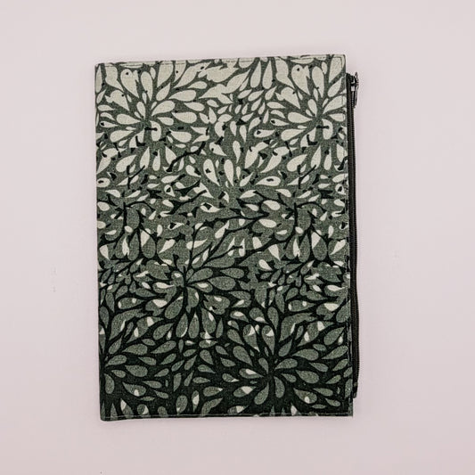 Folded fabric with leaf pattern on a light gray background