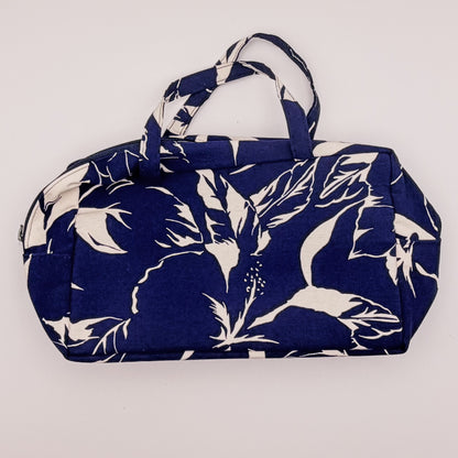Navy blue bag with white floral pattern on a light gray background