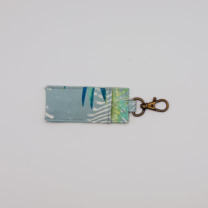 Fabric key fob with leaf pattern on a light gray background