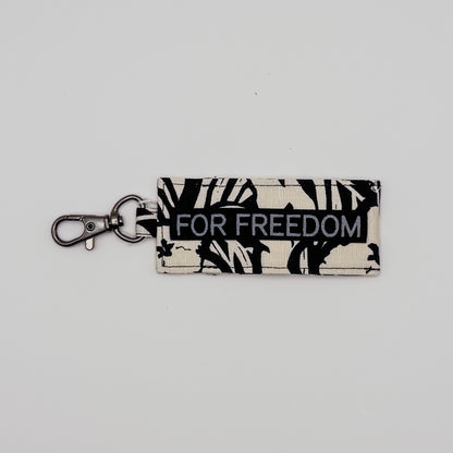 Keychain with 'FOR FREEDOM' text on a light gray background