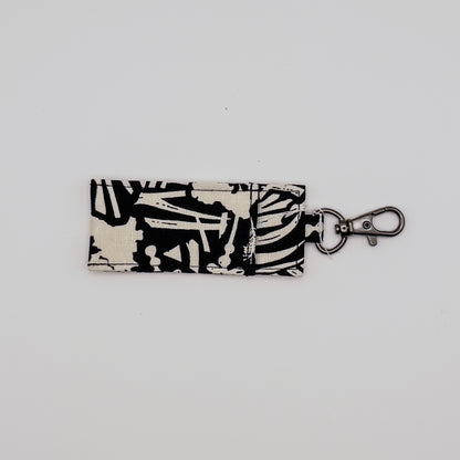 Keychain with black and white pattern on a light gray background