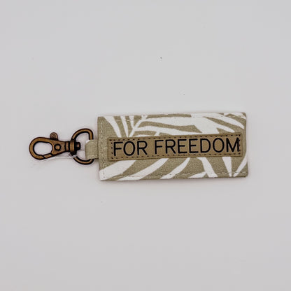 Keychain with 'FOR FREEDOM' text on a light background
